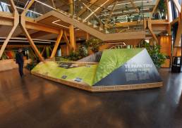 A visitor male stands in front of the interpretive display in the Scion Innovation Hub designed and produced by Gibson international