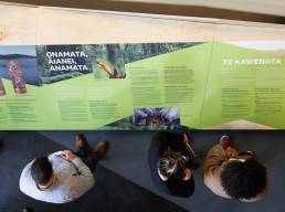 Visitors look at the interpretive signage in the Scion Innovation Hub designed and produced by Gibson International